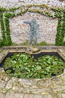 The Demi Lune small pond with waterlilies and Archer Sundial by Robert Rattray.
