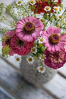 Zinnia, Dill and Daisies in a speckled ceramic vase.
