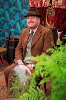 Matt Biggs channelling plant hunter Ernest Wilson in the Plant Hunter's Parlour, designed by Joe Swift. RHS Malvern Spring Festival, UK, 2017.