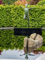 'The Leaf Creative Garden: A Garden of Quiet Contemplation' - view across pond with rock and a sculpture
 by Simon Gudgeon