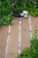 'Find Yourself Lost in the Moment' garden - looking down on path made of  mixed materials