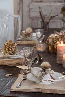 Dried Hydrangea and vintage book table and place setting with glasses and lit candles