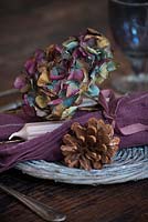 Dried Hydrangea flowerhead and cone place setting