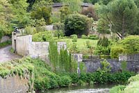 View across the River Stour to the walled garden at Iford Manor, Bradford-on-Avon, Wiltshire, UK. 