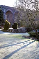Frosty lawn and evergreen borders at Kilver Court, Somerset, UK. Designed by Roger Saul of Mulberry.