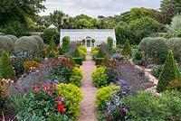 A fully restored Victorian walled kitchen garden is planted with a mix of annual flowers, herbs, fruits and vegetables.
