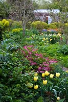 Spring borders and blossoming trees at Charleston, East Sussex.