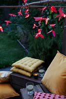Fairylights decorated with colourful paper shapes to create beautiful decorative outdoor lighting