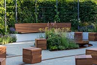 A relaxed seating area within a community space dedicated to physical and mental wellbeing. Crest Nicholson Livewell Garden, designed by Aleksandra Bartczak, RHS Hampton Court Palace Garden Festival, 2019.