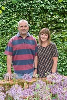 Garry and Alison Szafranski in their front garden. Behind a hornbeam hedge, in front a bed of Allium cristophii.