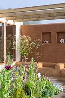 Studio with cob and clay plastered outdoor seating and pergola, jar of Cow Parsley - An Artist's Studio Home - Green Living Spaces, RHS Malvern Spring Festival 2019