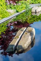 Split boulder from The Forest of Dean in a reflective pool - The Leaf Creative Garden - A Garden of a quiet contemplation - RHS Malvern Spring Festival 2009