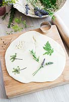 Salt dough with pressed flowers and leaves and biscuit cutter for shapes 