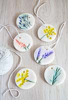 Salt dough gift tags decorated with impressions of flowers then painted 