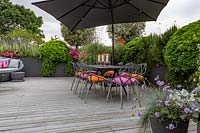 Roof garden with dining table and chairs.