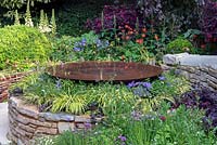 Circular Drystone raised bed with domed water dish in The Kingston Maurward Garden at RHS Chelsea Flower Show 2019