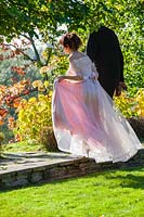 Recently married couple in the garden. Orekhovno garden, Orekhovno, Pskov Oblast region, Western Russia.