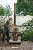 Mistletoe Nursery  - arranging fruit in copper boiler with fire.