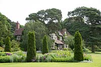 A view of Abbeywood House, an Edwardian residence built in 1908, seen accross a herbaceous border with prepeated conifers