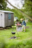 View to sherherds hut, outside dining area and cooking facility all set in Wild Meadows