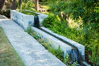 Concrete spring water fountain, Mill Creek ranch in Vanderpool, Texas, USA designed by Ten Eyck Landscape Architects, July.