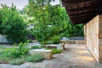 Paved area with seating and mixed planting at Mill Creek Ranch in Vanderpool, Texas designed by Ten Eyck Landscape Inc, July.