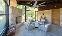 Limestone walls and stone paving inside modern living room at Mill Creek Ranch in Vanderpool, Texas designed by Ten Eyck Landscape Inc, July.