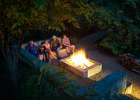 Family seated around the fire pit at Mill Creek Ranch Vanderpool, Texas designed by Ten Eyck Landscape Inc, July.