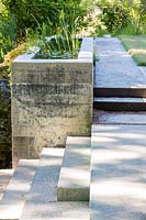 Concrete spring water feature and steps at Mill Creek ranch in Vanderpool, Texas, USA designed by Ten Eyck Landscape Architects, July.