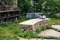 Drystone wall seat and fire pit. The Naturecraft Garden. RHS Hampton Court Palace Garden Festival, 2019.  