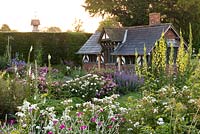 The Shrub Rose Garden. Borders of roses and perennials leading to the Tea House, a C19 folly.