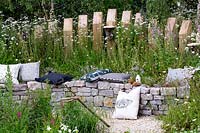 Drystone wall seat in wildlife friendly garden providing a habitat for bees and other insects. Springwatch Garden - Hampton Court Flower Show 2019