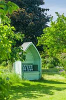 Pale green painted wooden garden arbour