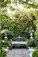 Ornate bench in Italian terrace garden, Milan, Italy. 