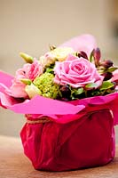 Gift wrapped arrangement of Roses, Hydrangea, Viburnum and Tulips