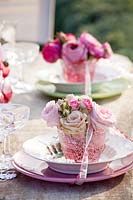 Wedding place setting decorated with roses
