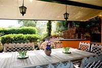 Dining area just outside the house with teak furnishings