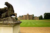 Statue and view of Rousham House over expansive lawn
