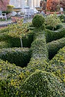 View along diagonal of a knot garden, terrace beyond