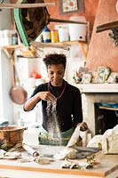 Woman working with clay in a studio