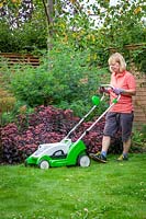 Raising the height of lawnmower blades before cutting a lawn during a dry spell