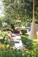Relaxed area in garden by Olea europaea - Olive - tree