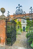 Manor House with wrought iron gateway and cobble front path