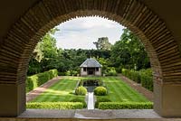 View of the Tranquility Pond and Loggia through the arch of the Thunder House. 