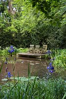 The Wild Pond with seating on a wooden decked platform. 