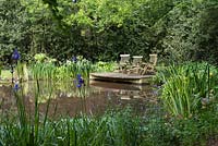 The Wild Pond with seating on a wooden decked platform. 