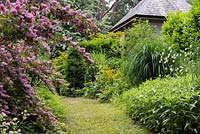 The Herbaceous Walk leading to the Tranquility Pond with the Thunder House behind. 