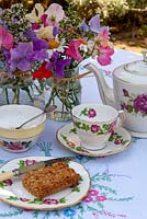 Jars of Sweet Peas, Lavender, Marguerite Daisies and Marjoram as table decorations together with setting for tea