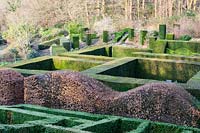 Formal country garden with low hedges of clipped Buxus Sempervirens and Wave-form Fagus Sylvatica 