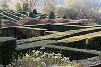  View over the Hydrangea bed of Ruin to the Grasses Parterre. Low hedges of clipped Buxus Sempervirens - Box, Wave-form hedge of Fagus Sylvatica - Beech, High hedges and cones of Taxus baccata - Yew.